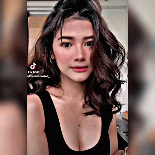 Woman in Black Tank Top TikTok on Shoulder