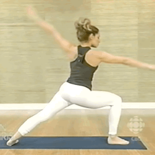 Woman in Black Tank Top White Pants Yoga