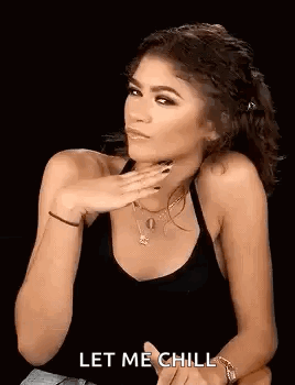 Woman in Black Tank Top With Hand on Chin
