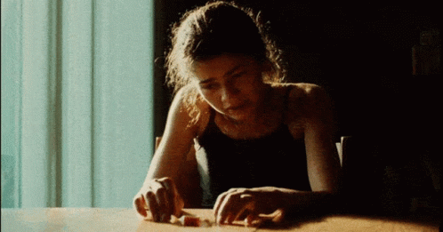 Woman in Black Tank Top with Hands on Table