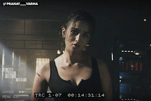 Woman In Black Tank Top With Pranay Varma On Screen GIF