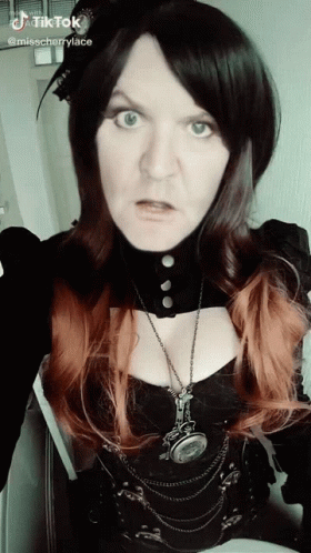 Woman in Black Top and Necklace With TikTok