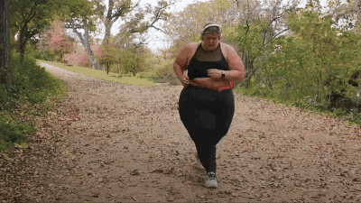 Woman in Black Top and Pants Running Down Dirt Path