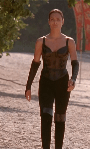 Woman in Black Top and Pants Walking Down Dirt Path
