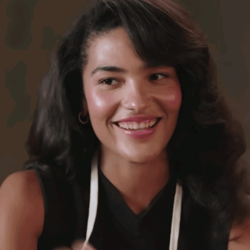 Woman In Black Top And White Apron Smiling GIF