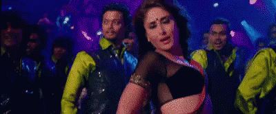 Woman in Black Top Dancing in Front of Men in Yellow Shirts