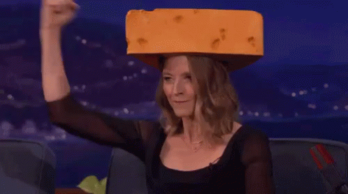 Woman in Black Top Holding Cheese on Head