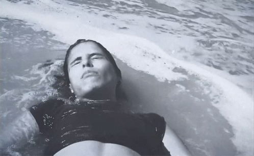 Woman in Black Top Lying in Water