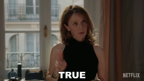 Woman in Black Top Says True in Front of Window