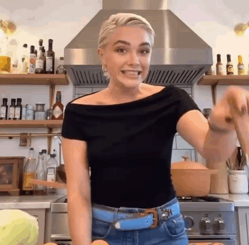 Woman in Black Top with Pot in Kitchen