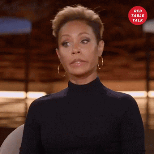Woman in Black Turtleneck and Gold Hoop Earrings