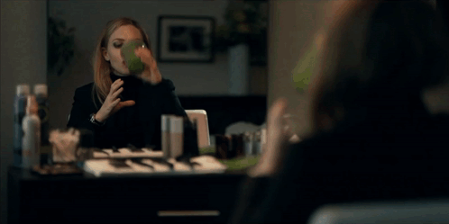 Woman in Black Turtleneck Drinking Green Smoothie