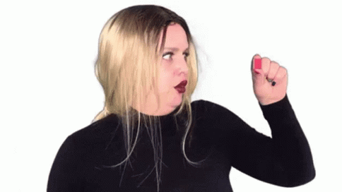 Woman in Black Turtleneck Holding Red Nail Polish