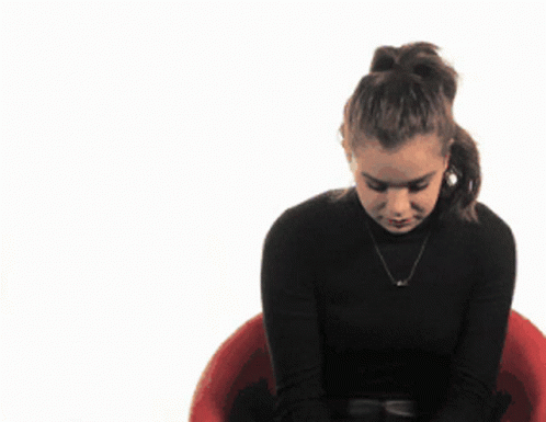 Woman In Black Turtleneck Sitting In Red Chair GIF