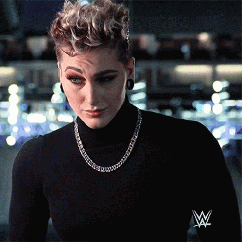 Woman in Black Turtleneck with Wrestling Logo