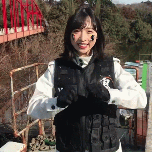 Woman in Black Vest With Letter V Smiling