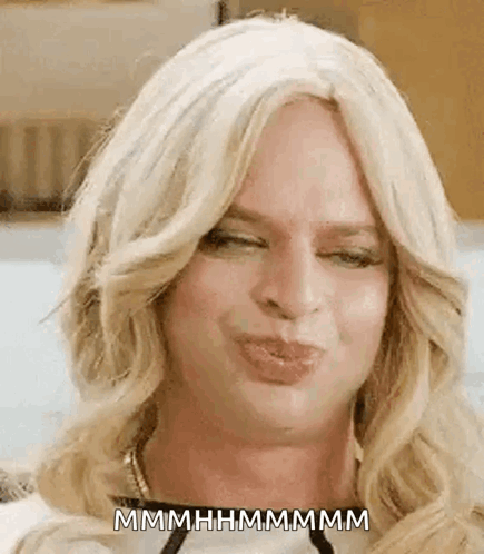 Woman in Blonde Wig Blowing Kiss