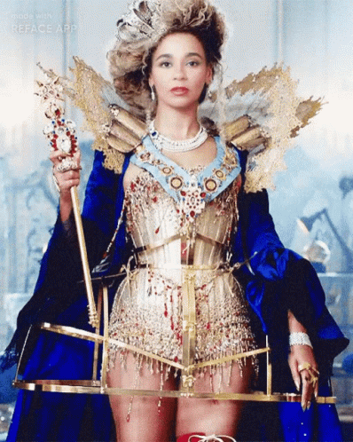 Woman in Blue and Gold Costume Holding Scepter