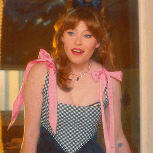 Woman in Blue and White Checkered Top with Pink Bow