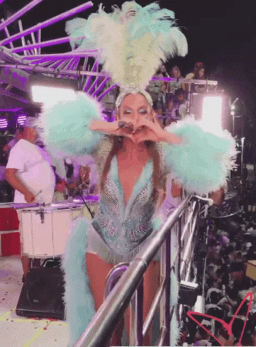 Woman in Blue and White Feathered Costume on Stage