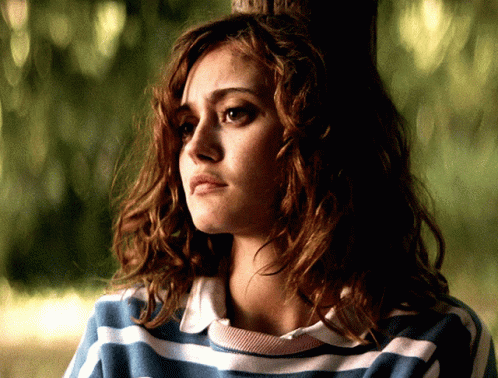 Woman in Blue and White Striped Shirt Looks Sad