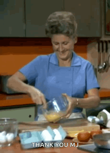 Woman in Blue Apron Mixing Eggs Saying Thank You Mj