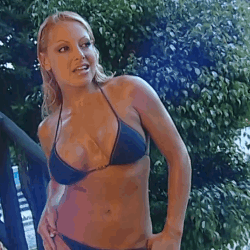 Woman in Blue Bikini Standing in Front of Tree