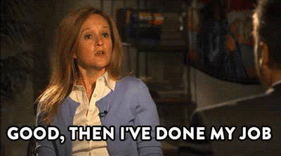 Woman In Blue Cardigan Talking To Man In Suit GIF