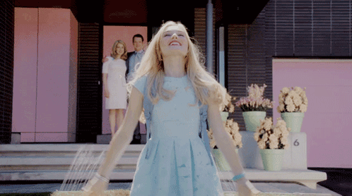 Woman in Blue Dress at Pink Building Number 6
