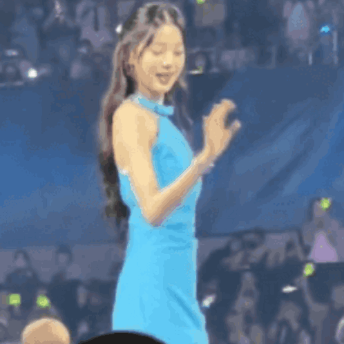 Woman In Blue Dress Clapping Before Crowd GIF