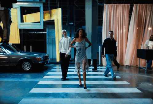 Woman In Blue Dress Crossing Crosswalk GIF
