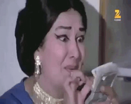 Woman in Blue Dress Crying Holding Paper