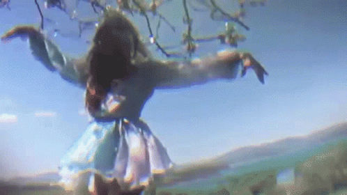 Woman in Blue Dress Dancing Under Tree
