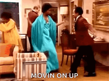 Woman in Blue Dress Dancing With Man in Red Suit