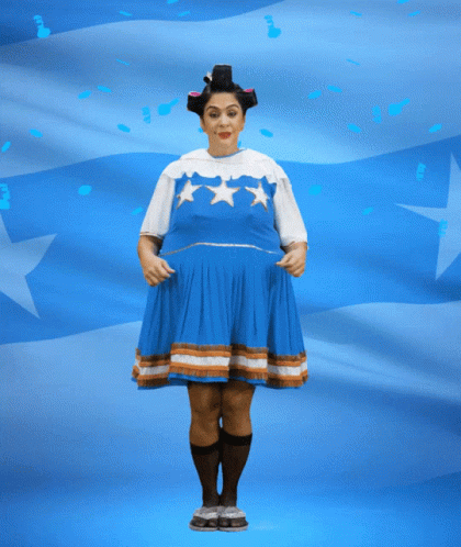 Woman in Blue Dress Holding Banner Saying Felices Fies