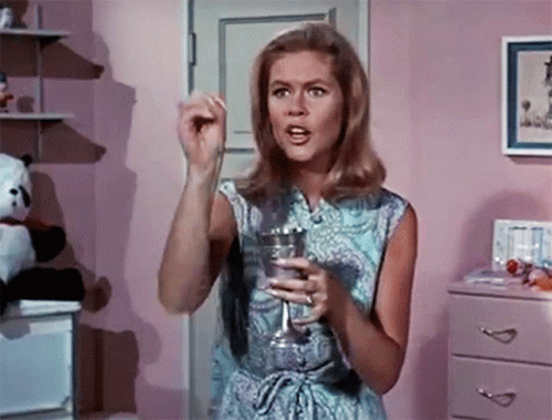 Woman in Blue Dress Holding Glass