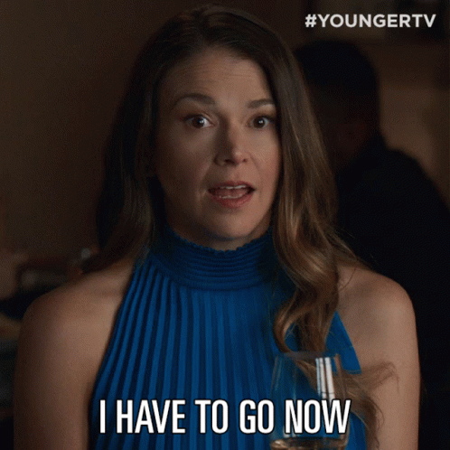 Woman in Blue Dress Holding Glass Saying I Have to Go Now