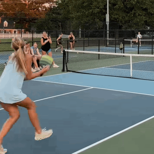 Woman in Blue Dress Holding Tennis Racquet
