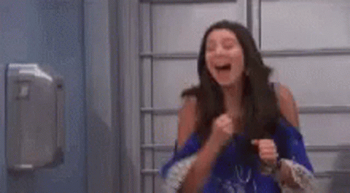 Woman in Blue Dress Laughing and Fist Pump
