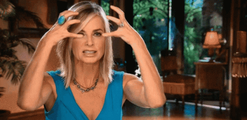 Woman In Blue Dress Making Funny Face GIF