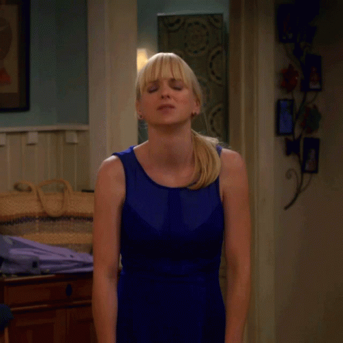 Woman in Blue Dress Near Dammit Sign