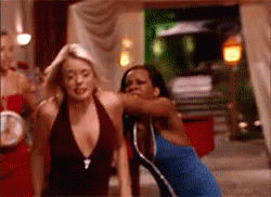 Woman in Blue Dress Next to Woman in Brown Top