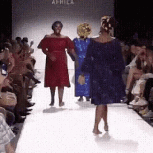 Woman in Blue Dress on Runway at Africa Fashion Show