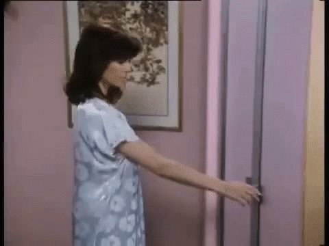 Woman in Blue Dress Opening Door