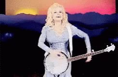 Woman in Blue Dress Playing Banjo and Singing