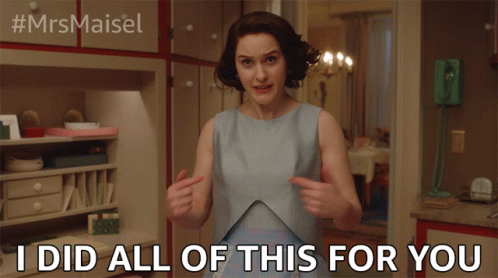 Woman in Blue Dress Pointing at Herself