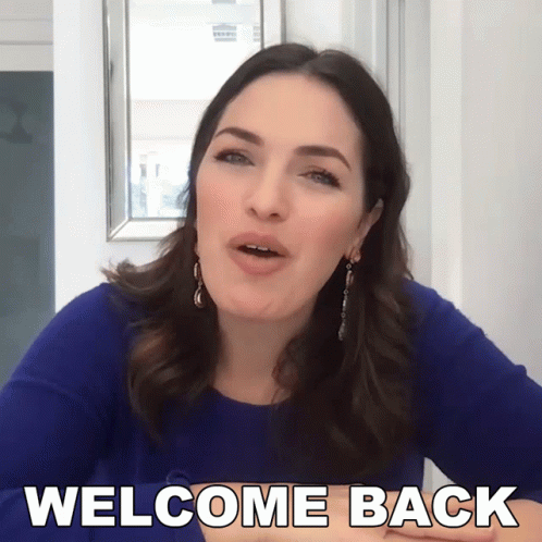 Woman in Blue Dress Saying Welcome Back