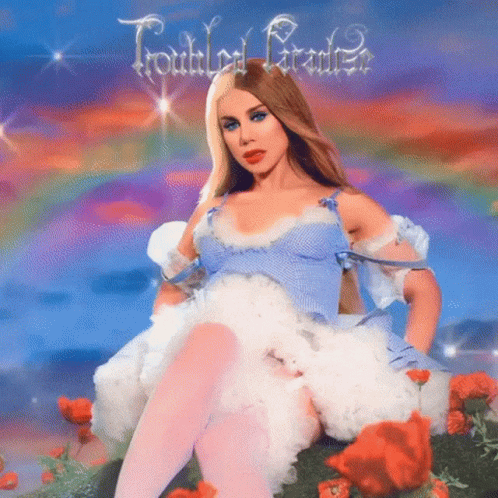 Woman in Blue Dress Sitting in Flower Field