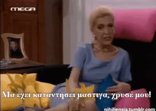 Woman in Blue Dress Sitting on Pink Couch With Mega Logo