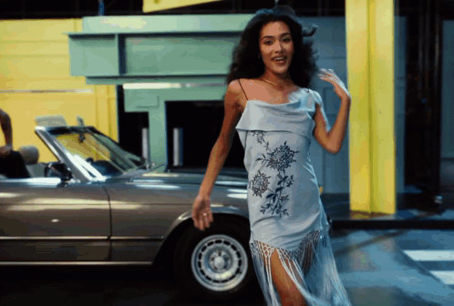 Woman In Blue Dress Standing By Silver Car GIF